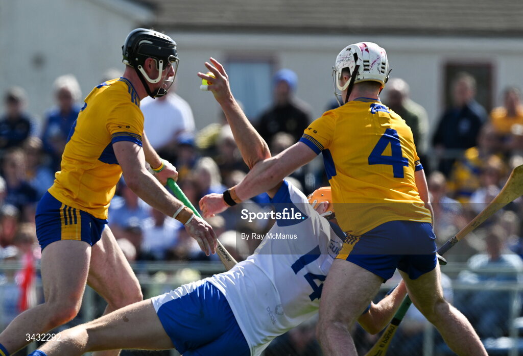 19 April 2026; Sean Walsh of Waterford is tackled by Niall O'Farrell and Adam Hogan of Clare, 4, to win a penalty during the Munster GAA Senior Hurling Championship Round 1 match between Clare and Waterford at Zimmer Biomet Páirc Chíosóg in Ennis, Clare. Photo by Ray McManus/Sportsfile