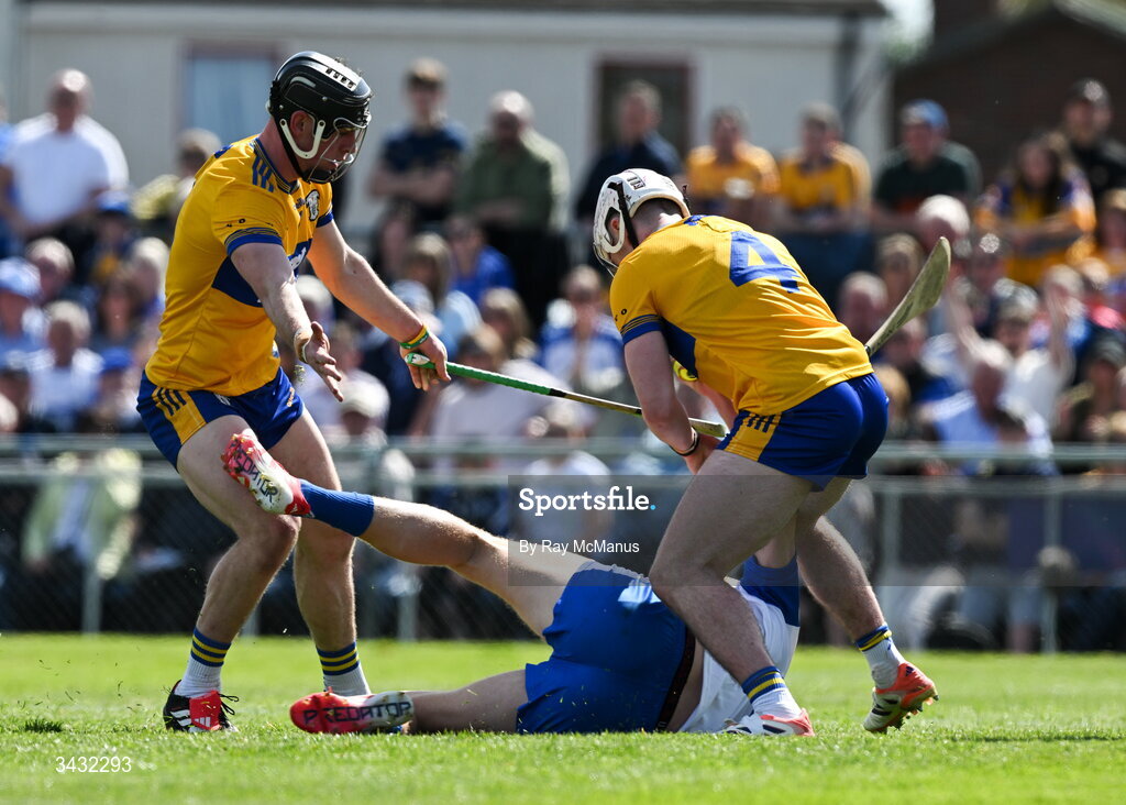 19 April 2026; Sean Walsh of Waterford is tackled by Niall O'Farrell and Adam Hogan of Clare, 4, to win a penalty during the Munster GAA Senior Hurling Championship Round 1 match between Clare and Waterford at Zimmer Biomet Páirc Chíosóg in Ennis, Clare. Photo by Ray McManus/Sportsfile