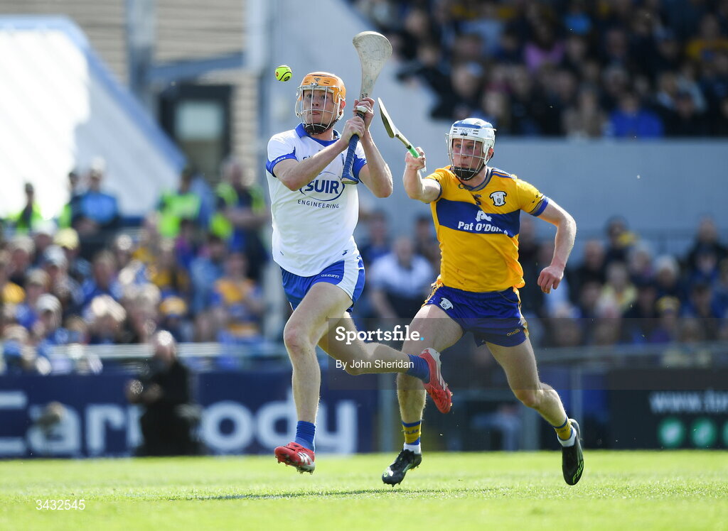 19 April 2026; Sean Walsh of Waterford shoots to score his side's fourth goal, despite the efforts of Diarmuid Ryan of Clare during the Munster GAA Senior Hurling Championship Round 1 match between Clare and Waterford at Zimmer Biomet Páirc Chíosóg in Ennis, Clare. Photo by John Sheridan/Sportsfile