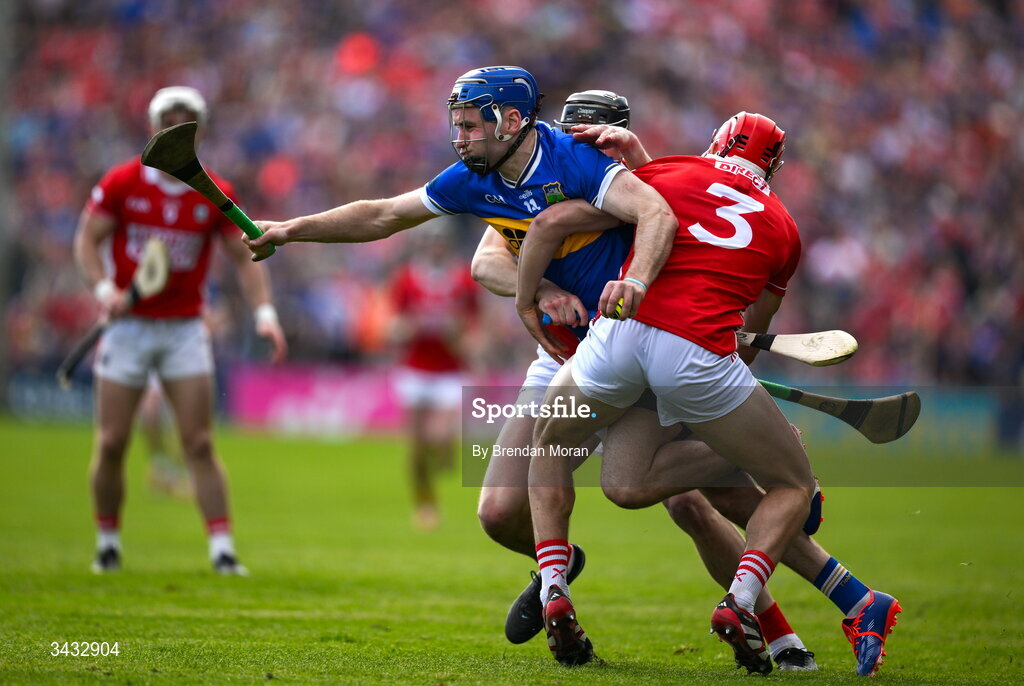 19 April 2026; John McGrath of Tipperary is tackled by Robert Downey and Ciarán Joyce of Cork during the Munster GAA Senior Hurling Championship Round 1 match between Tipperary and Cork at FBD Semple Stadium in Thurles, Tipperary. Photo by Brendan Moran/Sportsfile