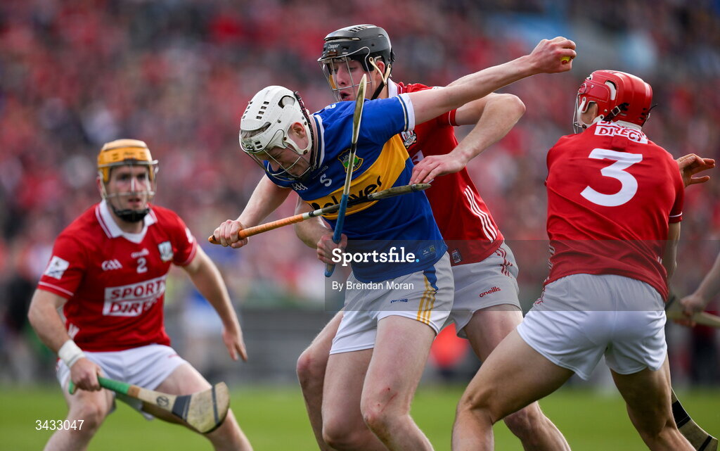 19 April 2026; Oisin O'Donoghue of Tipperary is tackled by Robert Downey of Cork during the Munster GAA Senior Hurling Championship Round 1 match between Tipperary and Cork at FBD Semple Stadium in Thurles, Tipperary. Photo by Brendan Moran/Sportsfile