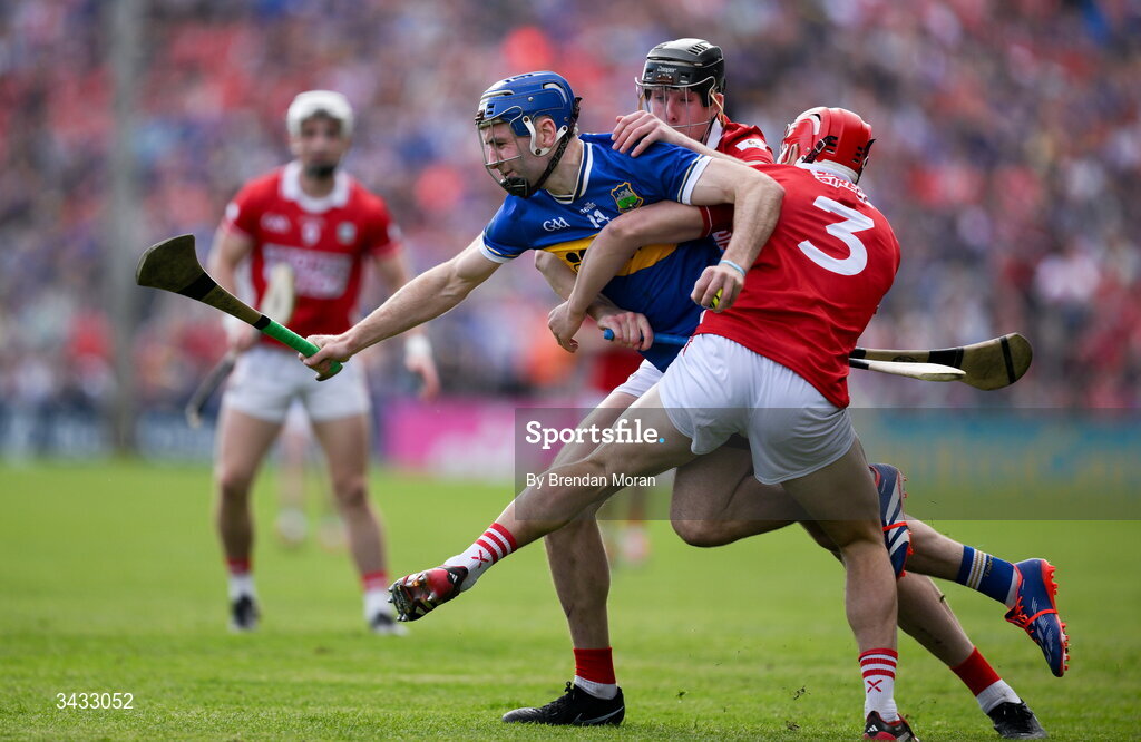 19 April 2026; John McGrath of Tipperary is tackled by Robert Downey and Ciarán Joyce of Cork during the Munster GAA Senior Hurling Championship Round 1 match between Tipperary and Cork at FBD Semple Stadium in Thurles, Tipperary. Photo by Brendan Moran/Sportsfile