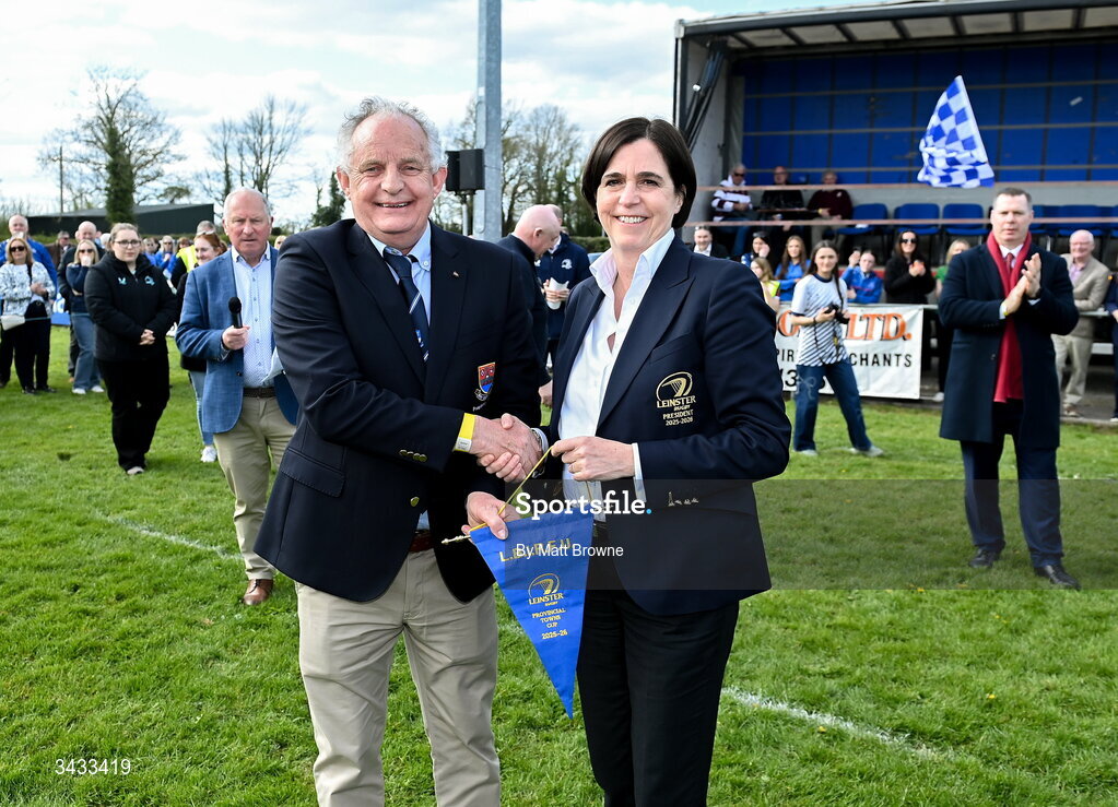 19 April 2026; Athy RFC president Adrian Conlan is presented with the winning pennant by Leinster presedent Moira Flahive after the Bank of Ireland Provincial Towns Cup Final match between Athy RFC and Tullow RFC at Edenderry RFC in Edenderry, Offaly. Photo by Matt Browne/Sportsfile