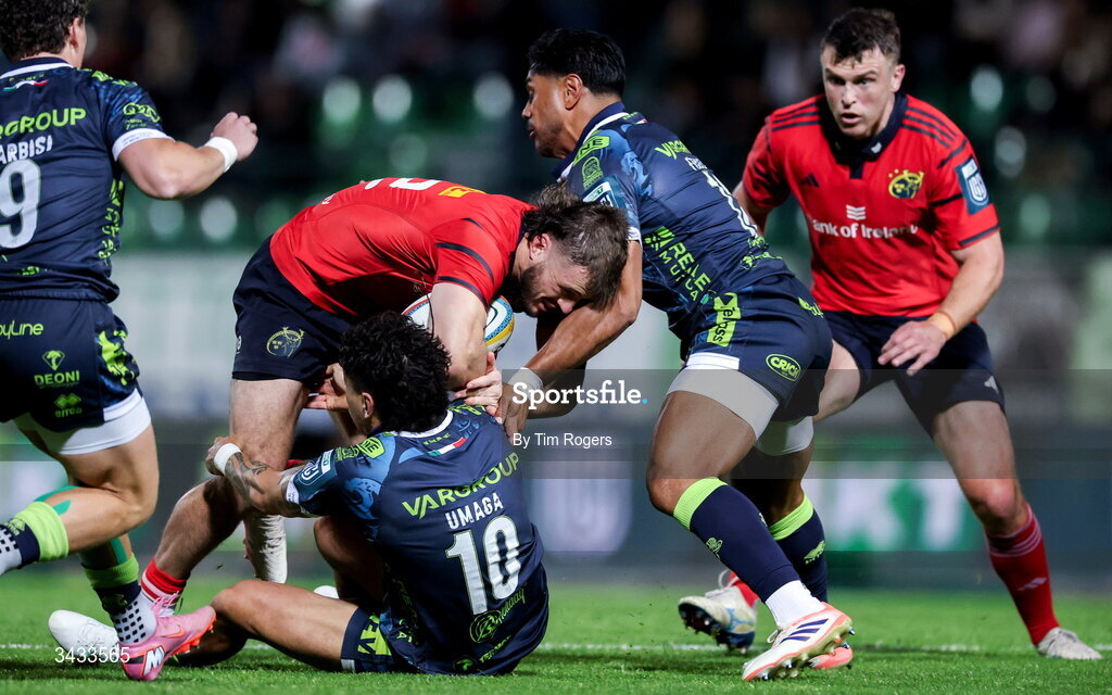 18 April 2026; Alex Nankivell of Munster is tackled by Jacob Umaga and Malakai Fekitoa of Benetton during the United Rugby Championship match between Benetton and Munster at Stadio Monigo in Treviso, Italy. Photo by Tim Rogers/Sportsfile