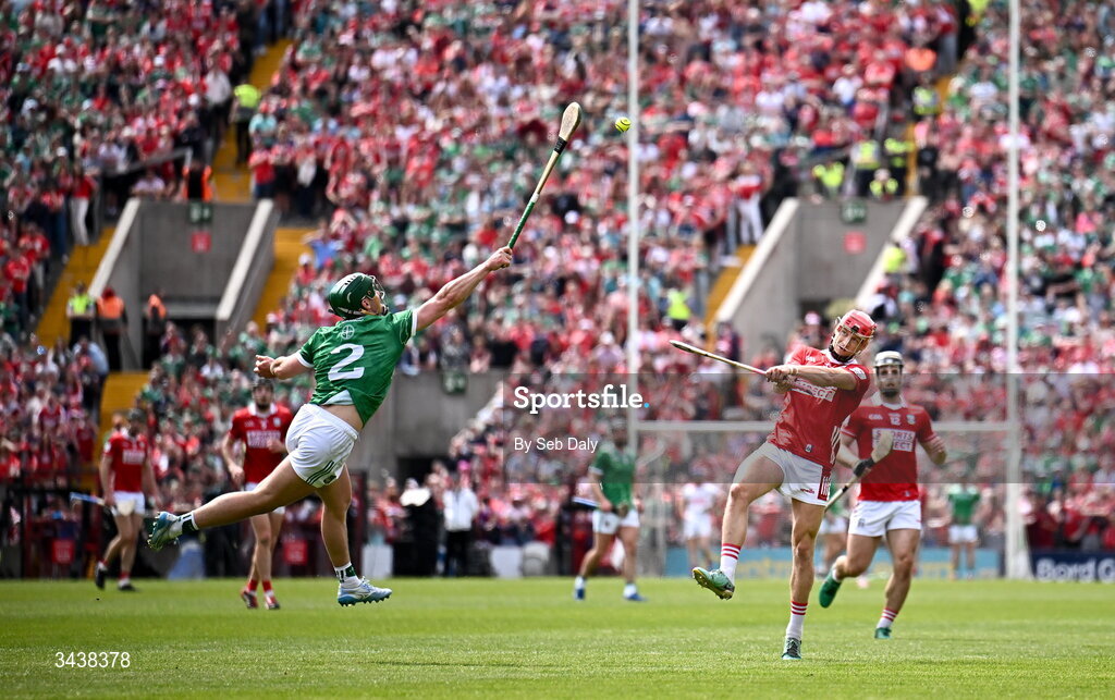 26 April 2026; Alan Connolly of Cork scores a point, under pressure from Limerick's Sean Finn, during the Munster GAA Senior Hurling Championship Round 2 match between Cork and Limerick at SuperValu Páirc Uí Chaoimh in Cork. Photo by Seb Daly/Sportsfile