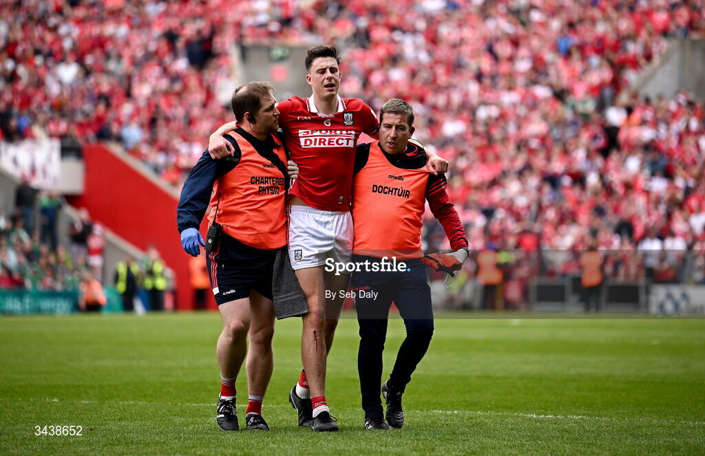 26 April 2026; Robert Downey of Cork leaves the pitch with medical staff during the Munster GAA Senior Hurling Championship Round 2 match between Cork and Limerick at SuperValu Páirc Uí Chaoimh in Cork. Photo by Seb Daly/Sportsfile