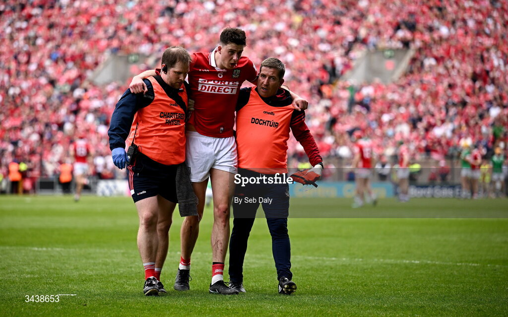 26 April 2026; Robert Downey of Cork leaves the pitch with medical staff during the Munster GAA Senior Hurling Championship Round 2 match between Cork and Limerick at SuperValu Páirc Uí Chaoimh in Cork. Photo by Seb Daly/Sportsfile