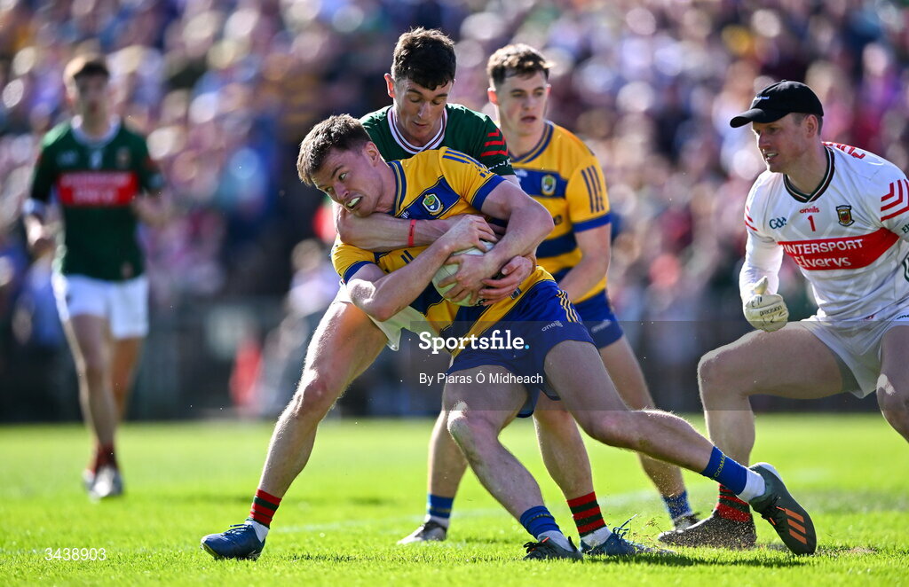 26 April 2026; Darragh Heneghan of Roscommon is tackled by Jack Coyne of Mayo during the Connacht GAA Football Senior Championship semi-final match between Mayo and Roscommon at Hastings Insurance MacHale Park in Castlebar, Mayo. Photo by Piaras Ó Mídheach/Sportsfile