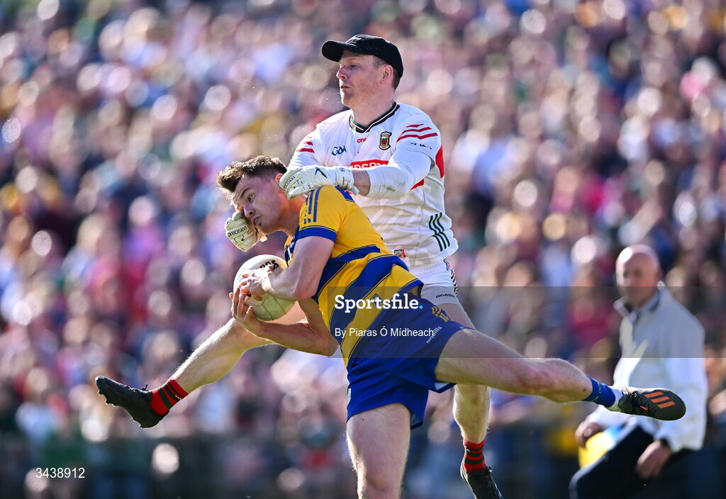 26 April 2026; Darragh Heneghan of Roscommon is tackled by Mayo goalkeeper Robert Hennelly during the Connacht GAA Football Senior Championship semi-final match between Mayo and Roscommon at Hastings Insurance MacHale Park in Castlebar, Mayo. Photo by Piaras Ó Mídheach/Sportsfile