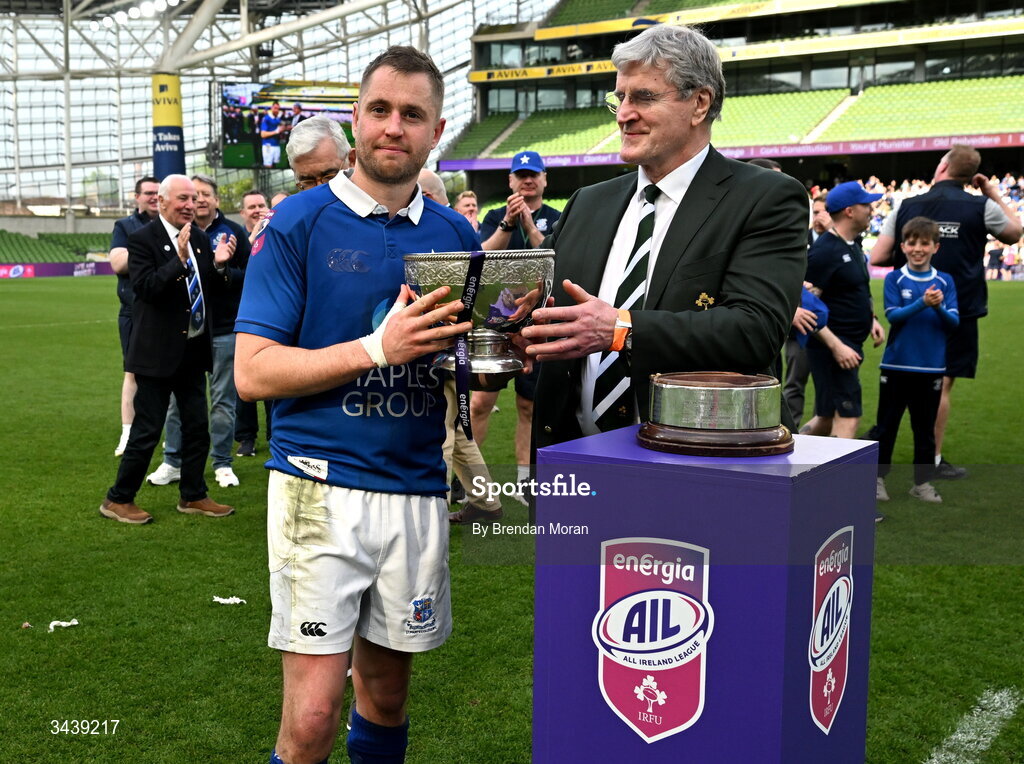 26 April 2026; St Mary's College RFC captain Conor Dean is presented with the Energia Men's AIL Division 1A trophy by IRFU president John O'Driscoll after during the Energia Men's All-Ireland League Division 1A final match between Clontarf FC and St Mary's College RFC at the Aviva Stadium in Dublin. Photo by Brendan Moran/Sportsfile