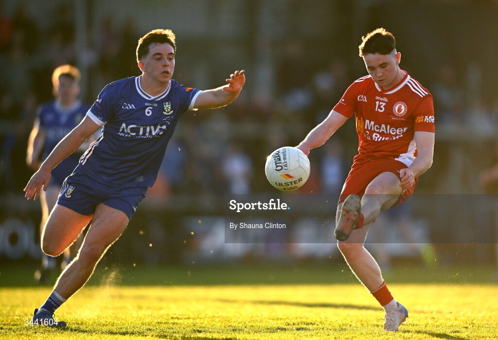 29 April 2026; Adrian McGurren of Tyrone kicks a score despite the efforts of Donnacha Connolly of Monaghan during the Dalata Hotel Group Ulster U20 Football Championship final match between Monaghan and Tyrone at BOX-IT Athletic Grounds in Armagh. Photo by Shauna Clinton/Sportsfile