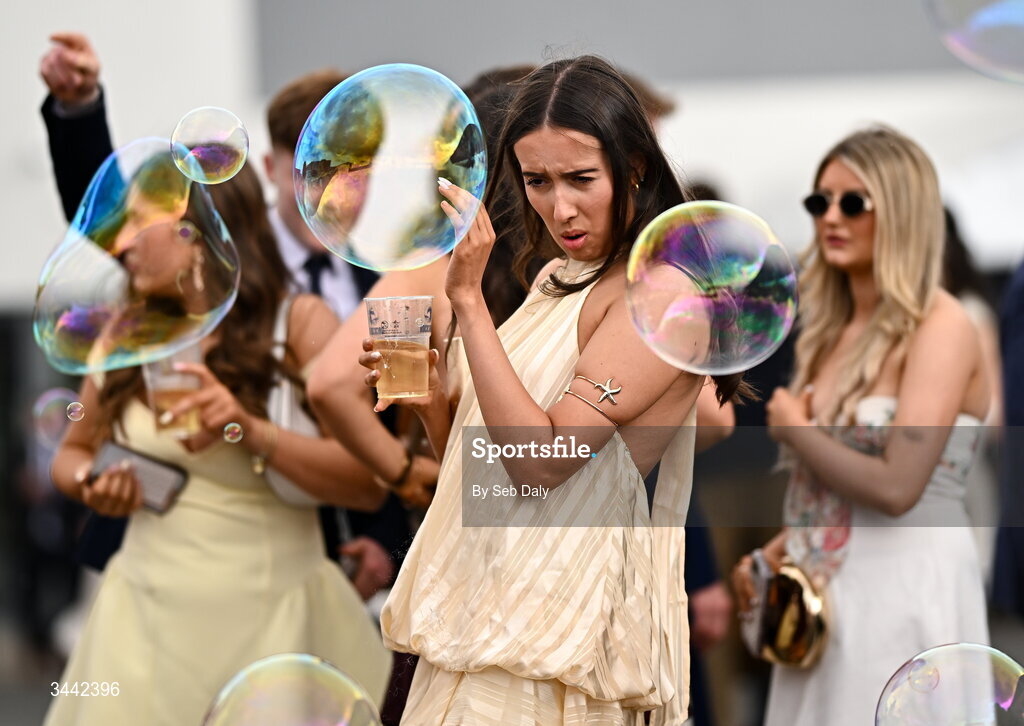 1 May 2026; A racegoer tries to avoid the bubbles ahead of racing on day four of the Punchestown Festival at Punchestown Racecourse in Kildare. Photo by Seb Daly/Sportsfile