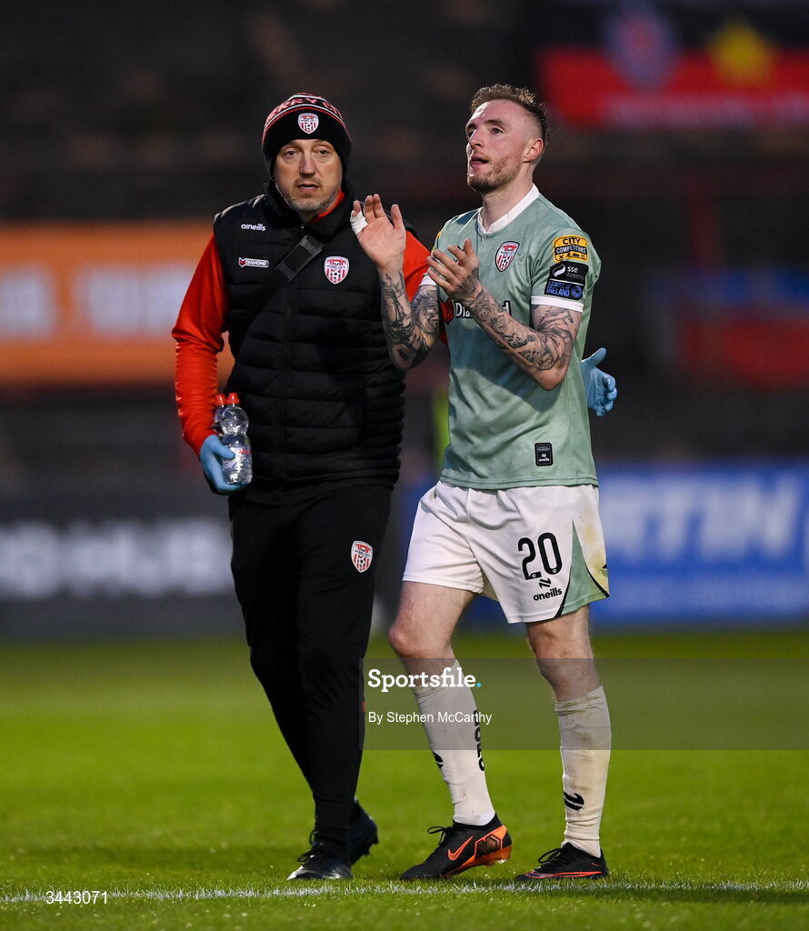 1 May 2026; Carl Winchester of Derry City leaves the pitch with physiotherapist Colum O'Neill during the SSE Airtricity Men's Premier Division match between Bohemians and Derry City at Dalymount Park in Dublin. Photo by Stephen McCarthy/Sportsfile