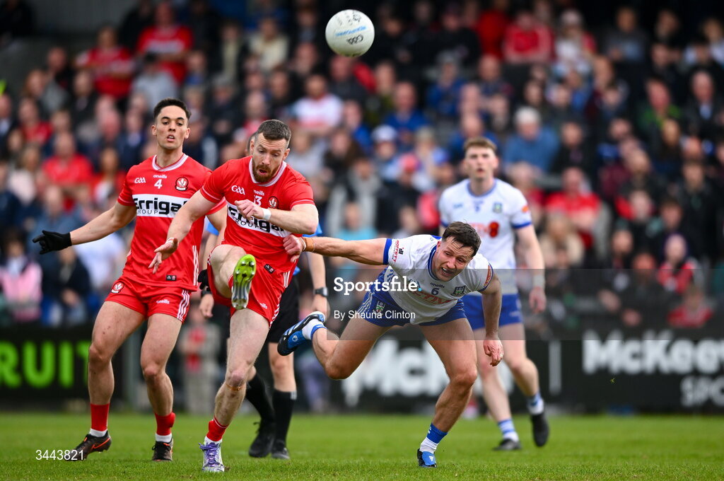 2 May 2026; Niall Loughlin of Derry kicks a point despite the efforts of Dessie Ward of Monaghan during the Ulster GAA Football Senior Championship semi-final match between Derry and Monaghan at BOX-IT Athletic Grounds in Armagh. Photo by Shauna Clinton/Sportsfile