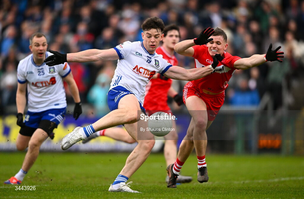 2 May 2026; David Garland of Monaghan has a shot on goal despite the efforts of Diarmuid Baker of Derry during the Ulster GAA Football Senior Championship semi-final match between Derry and Monaghan at BOX-IT Athletic Grounds in Armagh. Photo by Shauna Clinton/Sportsfile