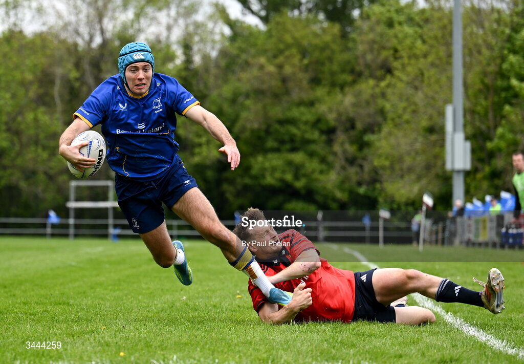 2 May 2026; Oisin McKenna of Leinster escapes the tackle of Jack O'Connell of Munster before scoring a try during the IRFU Men's Junior Interprovincials Round 2 match between Munster and Leinster at DLSP FC in Kiltiernan, Dublin. Photo by Paul Phelan/Sportsfile