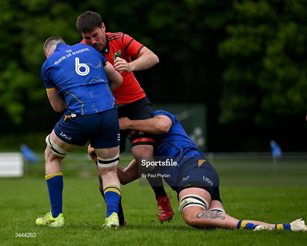 2 May 2026; Adam McEvoy of Munster is tackled by Colm Heffernan and Max Richards of Leinster during the IRFU Men's Junior Interprovincials Round 2 match between Munster and Leinster at DLSP FC in Kiltiernan, Dublin. Photo by Paul Phelan/Sportsfile