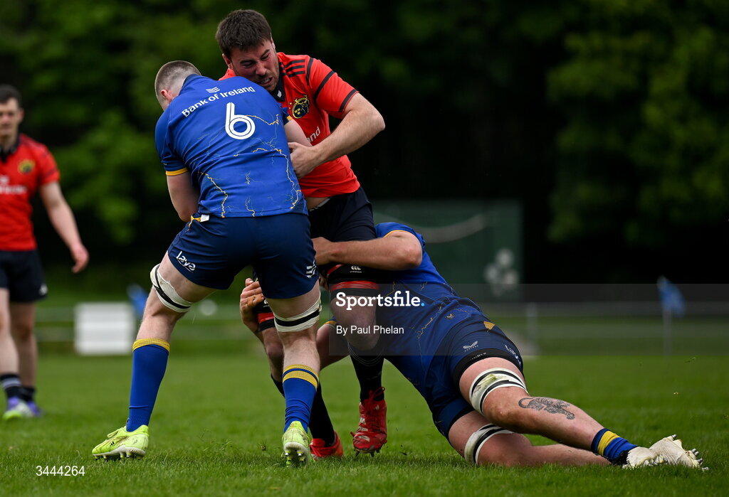2 May 2026; Adam McEvoy of Munster is tackled by Colm Heffernan and Max Richards of Leinster during the IRFU Men's Junior Interprovincials Round 2 match between Munster and Leinster at DLSP FC in Kiltiernan, Dublin. Photo by Paul Phelan/Sportsfile