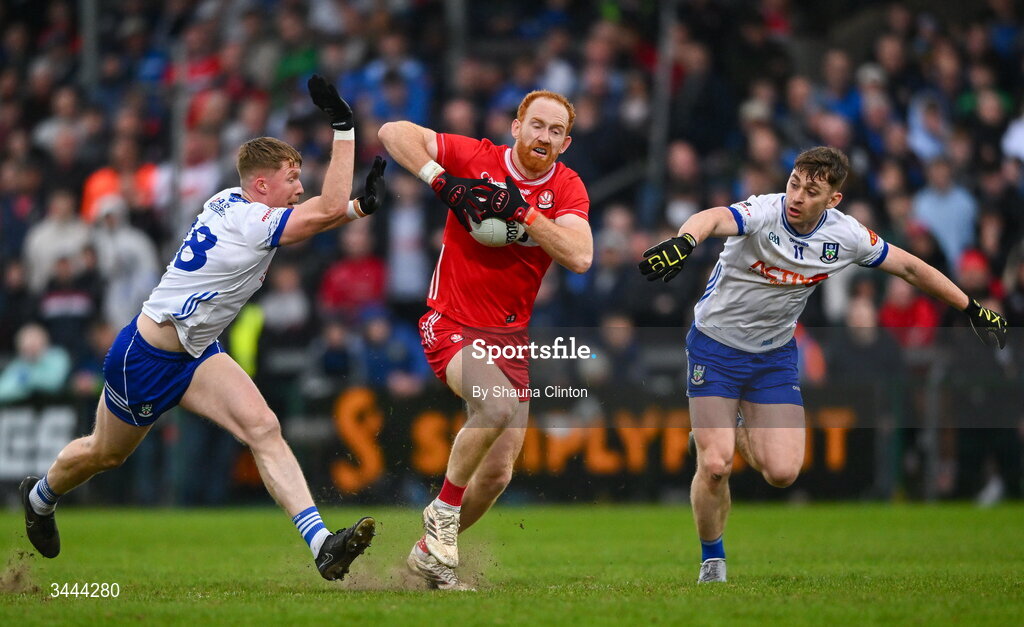 2 May 2026; Conor Glass of Derry in action against Monaghan players Ryan Duffy, left, and Micheal Bannigan during the Ulster GAA Football Senior Championship semi-final match between Derry and Monaghan at BOX-IT Athletic Grounds in Armagh. Photo by Shauna Clinton/Sportsfile
