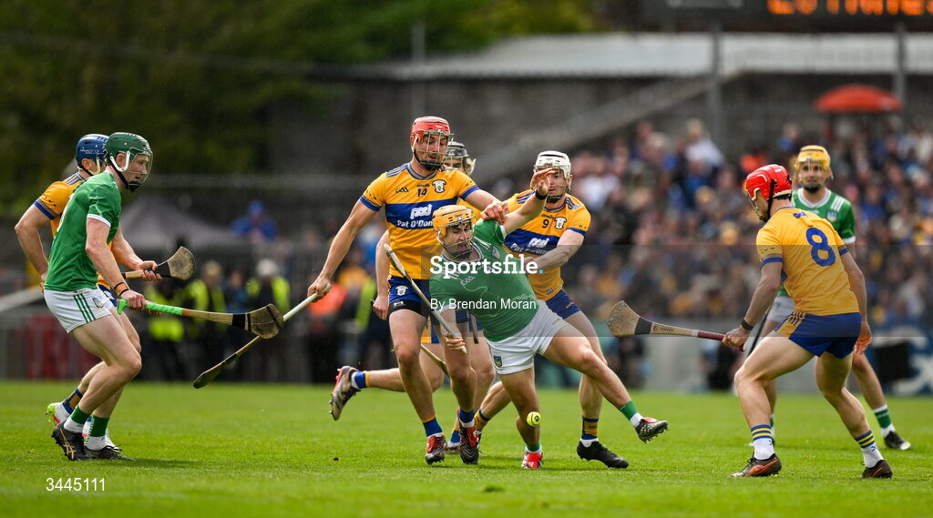3 May 2026; Adam English of Limerick is tackled by Peter Duggan and Ryan Taylor of Clare during the Munster GAA Senior Hurling Championship Round 3 match between Clare and Limerick at Zimmer Biomet Páirc Chíosóg in Ennis, Clare. Photo by Brendan Moran/Sportsfile