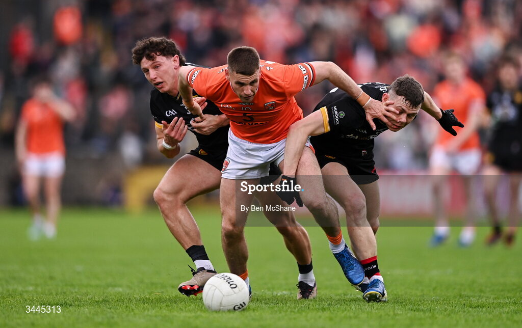 3 May 2026; Greg McCabe of Armagh is tackled by Pearse McPolin, right, and Pierce Laverty of Down during the Ulster GAA Football Senior Championship semi-final match between Armagh and Down at St Tiernach's Park in Clones, Monaghan. Photo by Ben McShane/Sportsfile