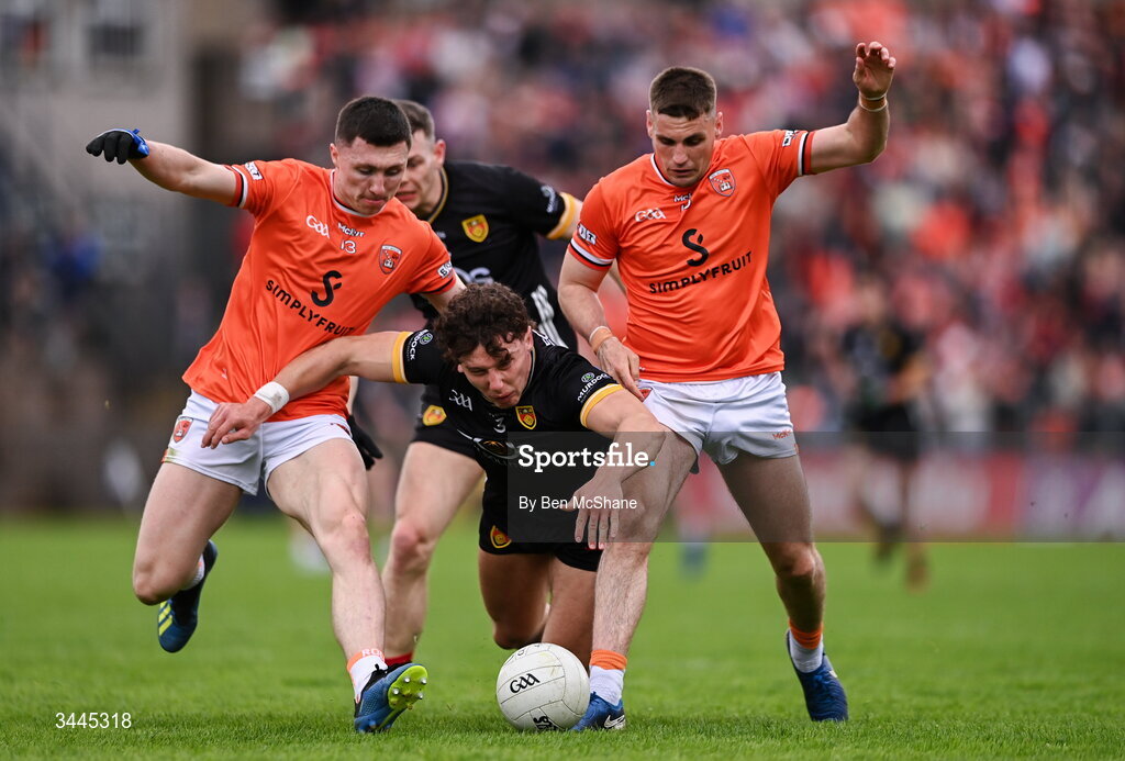 3 May 2026; Pierce Laverty of Down is tackled by Oisin Conaty, left, and Greg McCabe of Armagh during the Ulster GAA Football Senior Championship semi-final match between Armagh and Down at St Tiernach's Park in Clones, Monaghan. Photo by Ben McShane/Sportsfile