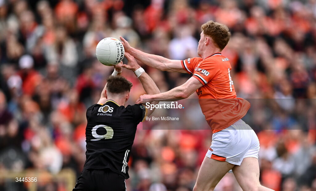 3 May 2026; Conor Turbitt of Armagh scores his side's second goal, despite the tackle of Ryan McEvoy of Down, during the Ulster GAA Football Senior Championship semi-final match between Armagh and Down at St Tiernach's Park in Clones, Monaghan. Photo by Ben McShane/Sportsfile