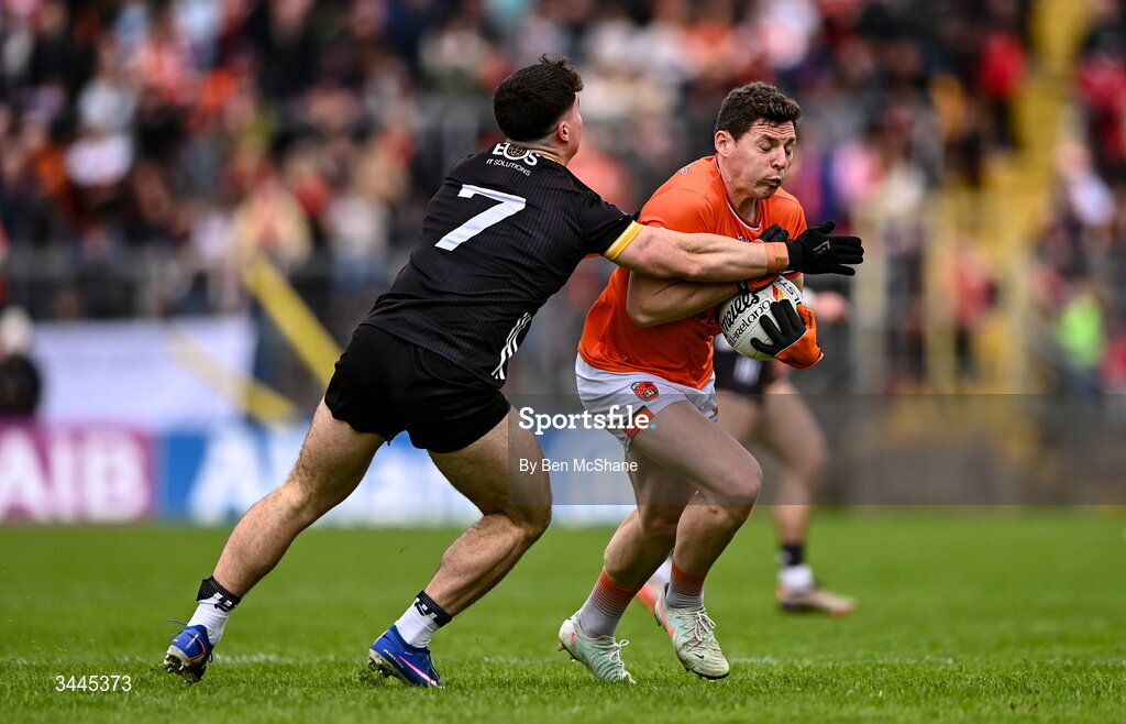 3 May 2026; Paddy Burns of Armagh is tackled by Daniel Guinness of Down during the Ulster GAA Football Senior Championship semi-final match between Armagh and Down at St Tiernach's Park in Clones, Monaghan. Photo by Ben McShane/Sportsfile