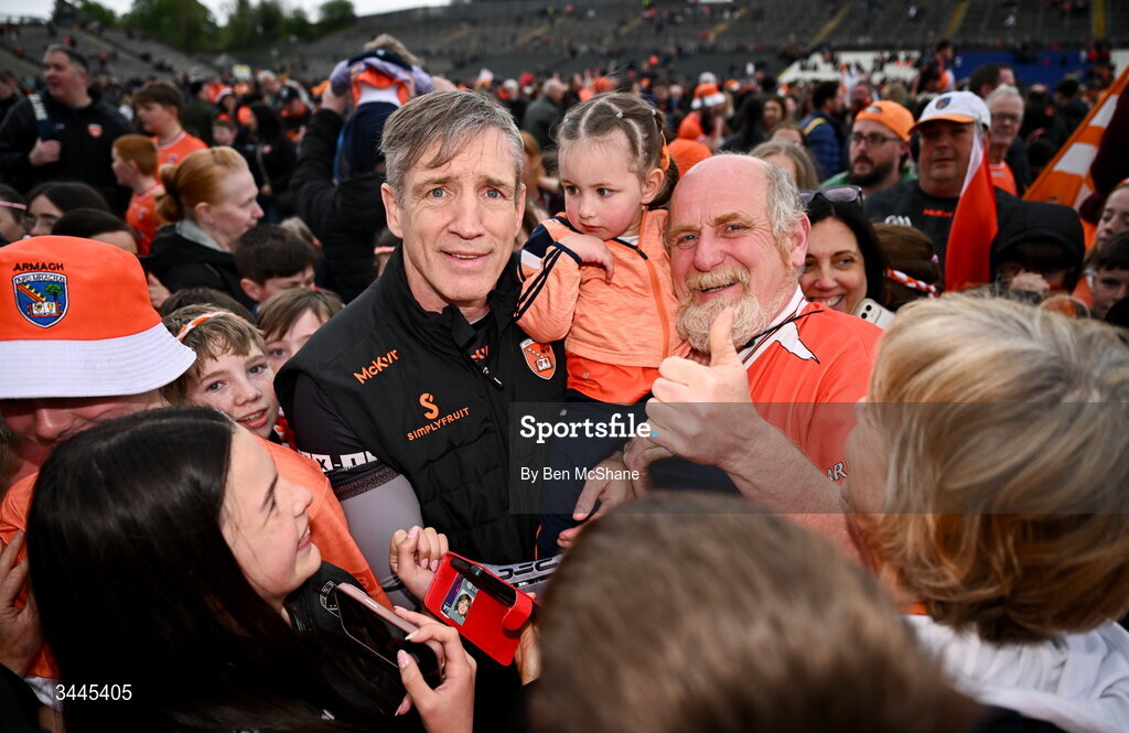 3 May 2026; Armagh manager Kieran McGeeney with Armagh supporters Paul McCormack, right, with his grand-daughter Cádhra Quinn, age 2, after the Ulster GAA Football Senior Championship semi-final match between Armagh and Down at St Tiernach's Park in Clones, Monaghan. Photo by Ben McShane/Sportsfile