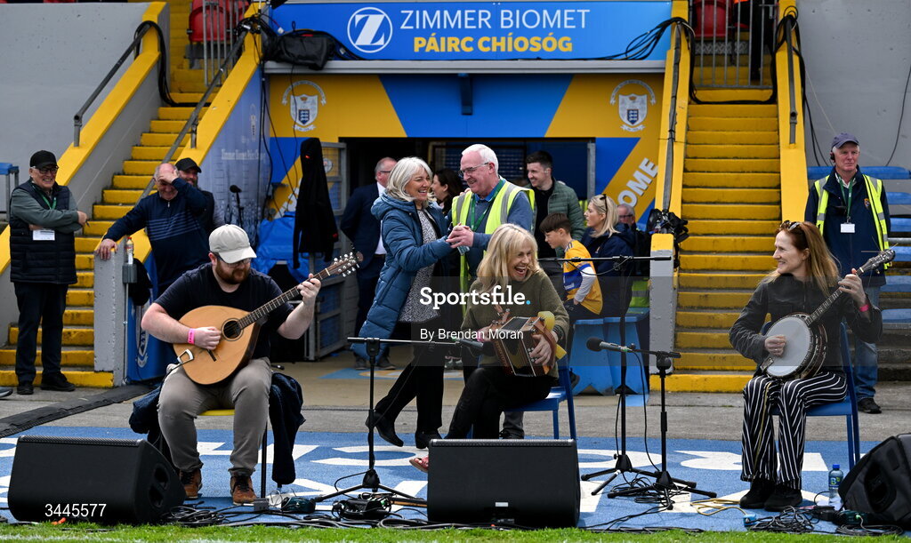 3 May 2026; Cusack Park maor Martin Keane and national anthem singer Denise Whelan dance a set while listening to musicians Killian and Sharon Shannon as they entertain the crowd before the Munster GAA Senior Hurling Championship Round 3 match between Clare and Limerick at Zimmer Biomet Páirc Chíosóg in Ennis, Clare. Photo by Brendan Moran/Sportsfile