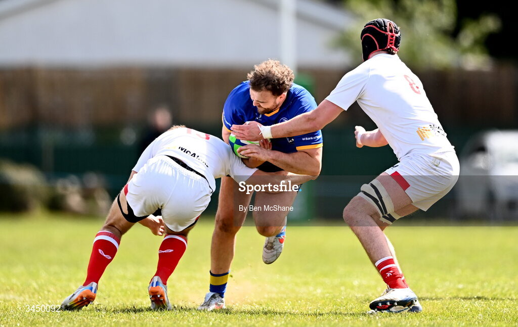 9 May 2026; Kyle Dixon of Leinster is tackled by Ethan Patterson, left, and Michael Rooney of Ulster during the IRFU Men's Junior Interprovincial Round 3 match between Ulster and Leinster at Lisburn RFC in Lisburn, Antrim. Photo by Ben McShane/Sportsfile