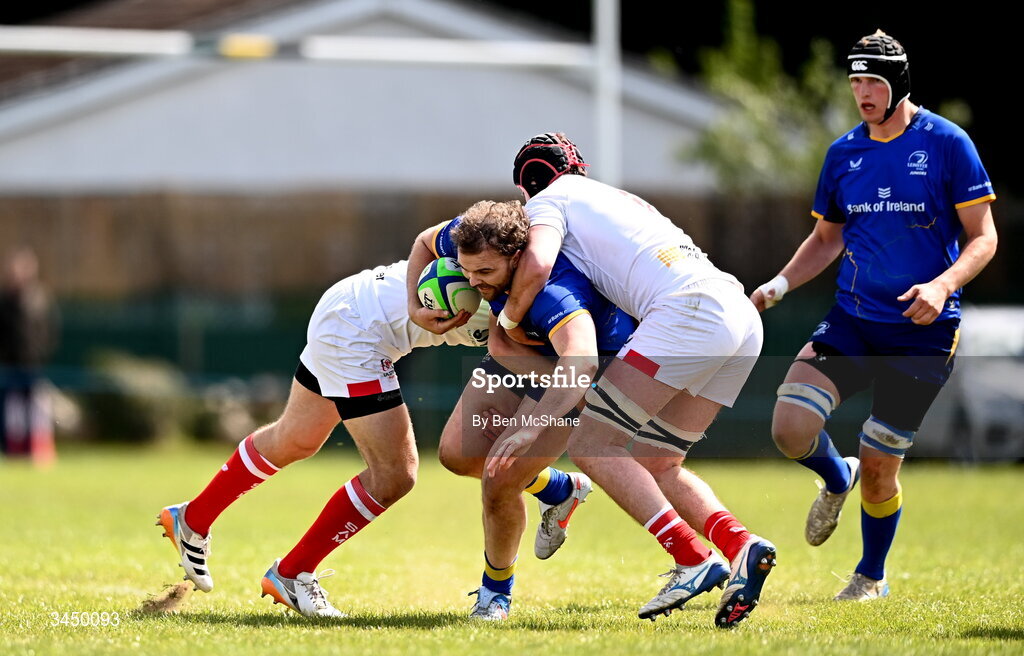 9 May 2026; Kyle Dixon of Leinster is tackled by Ethan Patterson, left, and Michael Rooney of Ulster during the IRFU Men's Junior Interprovincial Round 3 match between Ulster and Leinster at Lisburn RFC in Lisburn, Antrim. Photo by Ben McShane/Sportsfile