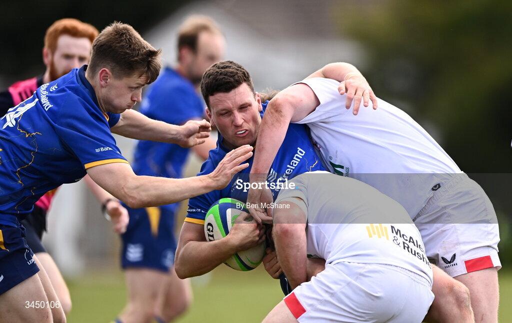 9 May 2026; Darragh White of Leinster is tackled by Ryan Hughes, bottom, and Michael Rooney of Ulster during the IRFU Men's Junior Interprovincial Round 3 match between Ulster and Leinster at Lisburn RFC in Lisburn, Antrim. Photo by Ben McShane/Sportsfile