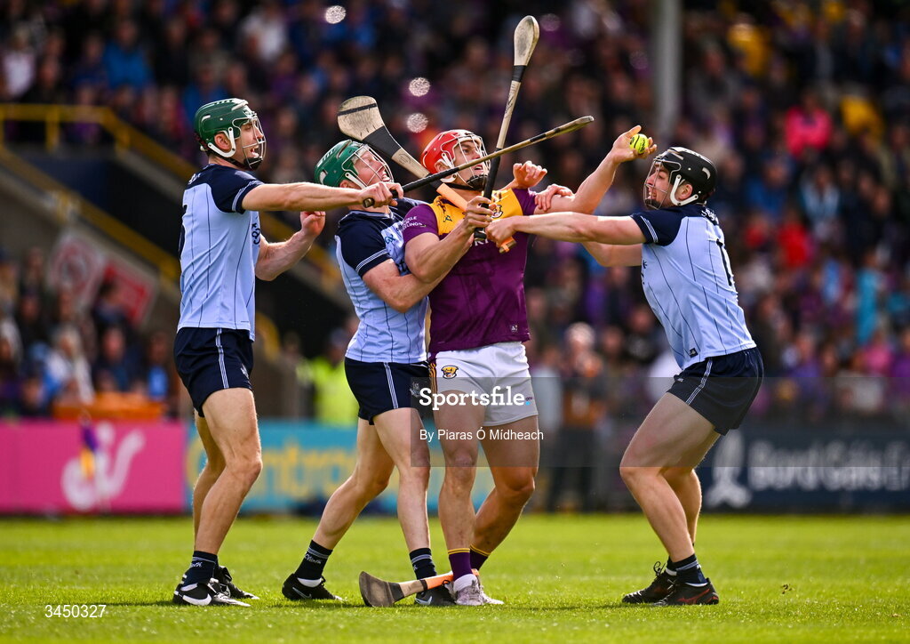 9 May 2026; Lee Chin of Wexford is tackled by Dublin players, from left, Chris Crummy, Fergal Whitely and Donal Burke during the Leinster GAA Senior Hurling Championship round 3 match between Wexford and Dublin at Chadwicks Wexford Park in Wexford. Photo by Piaras Ó Mídheach/Sportsfile
