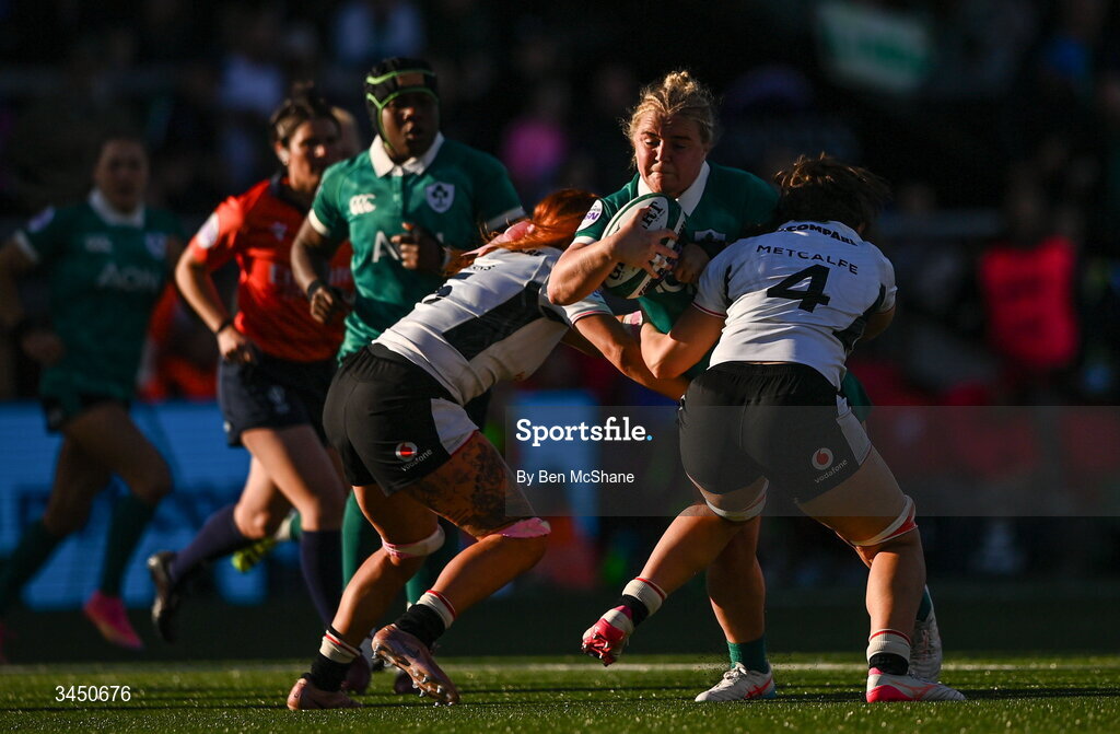9 May 2026; Clíodhna Moloney MacDonald of Ireland is tackled by Georgia Evans, left, and Branwen Metcalfe of Wales of Wales during the Women's 6 Nations Rugby Championship match between Ireland and Wales at Affidea Stadium in Belfast. Photo by Ben McShane/Sportsfile