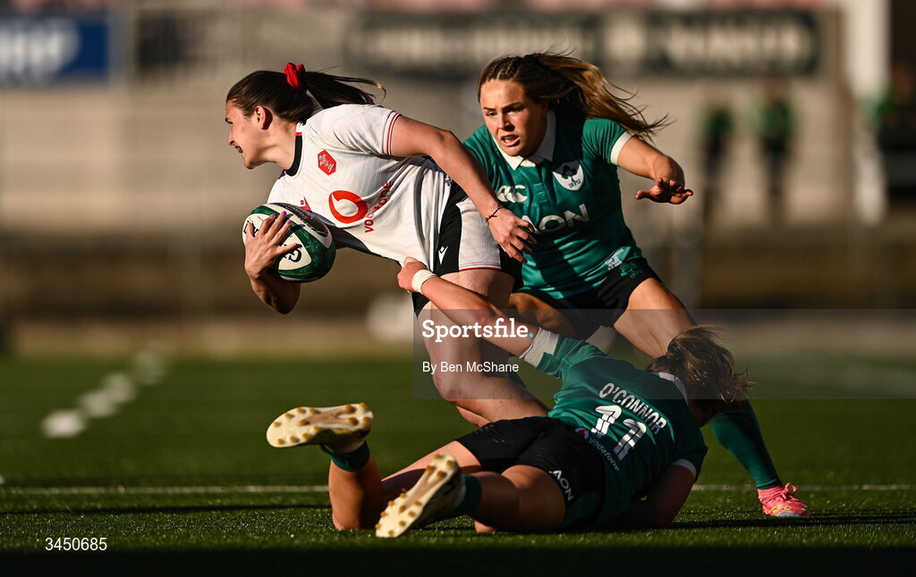 9 May 2026; Kayleigh Powell of Wales is tackled by Robyn O'Connor, bottom, and Béibhinn Parsons of Ireland during the Women's 6 Nations Rugby Championship match between Ireland and Wales at Affidea Stadium in Belfast. Photo by Ben McShane/Sportsfile
