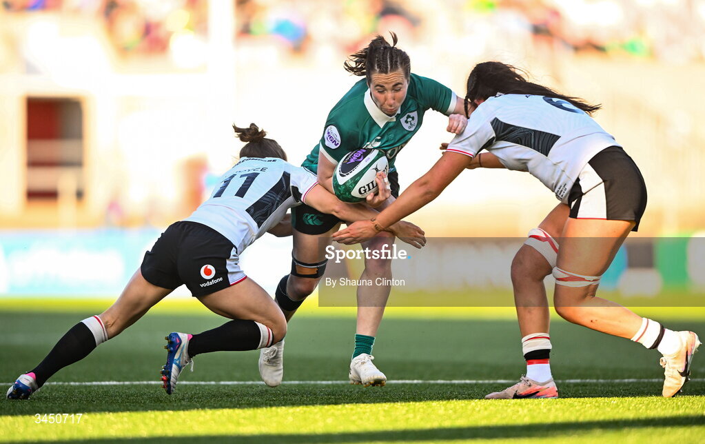 9 May 2026; Eve Higgins of Ireland is tackled by Wales players Jorja Aiono, left, and Jasmine Joyce during the Women's 6 Nations Rugby Championship match between Ireland and Wales at Affidea Stadium in Belfast. Photo by Shauna Clinton/Sportsfile