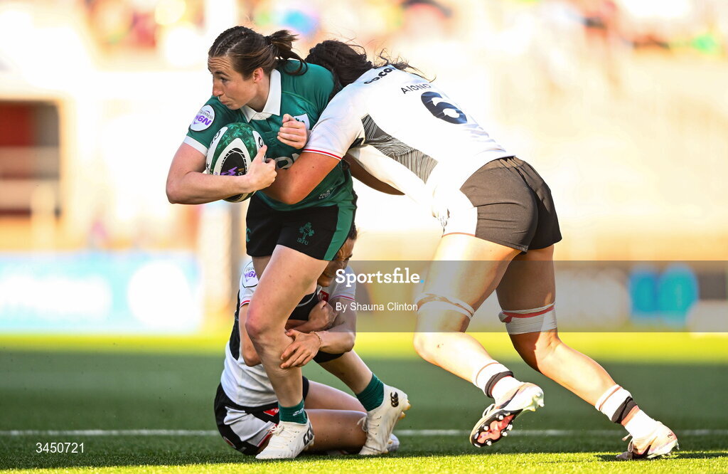 9 May 2026; Eve Higgins of Ireland is tackled by Wales players Jorja Aiono, left, and Jasmine Joyce during the Women's 6 Nations Rugby Championship match between Ireland and Wales at Affidea Stadium in Belfast. Photo by Shauna Clinton/Sportsfile