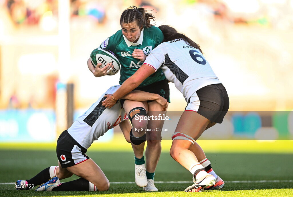9 May 2026; Eve Higgins of Ireland is tackled by Wales players Jorja Aiono, left, and Jasmine Joyce during the Women's 6 Nations Rugby Championship match between Ireland and Wales at Affidea Stadium in Belfast. Photo by Shauna Clinton/Sportsfile