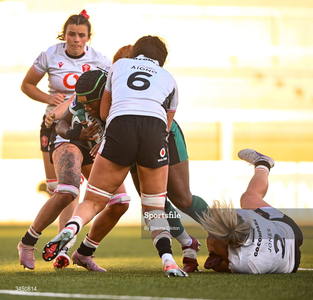 9 May 2026; Linda Djougang of Ireland is tackled by Wales players Jorja Aiono, left, and Kelsey Jones during the Women's 6 Nations Rugby Championship match between Ireland and Wales at Affidea Stadium in Belfast. Photo by Shauna Clinton/Sportsfile