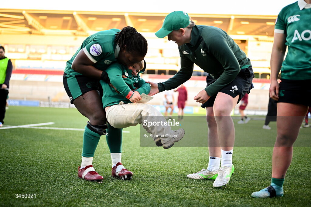 9 May 2026; Linda Djougang, left, and Beth Buttimer of Ireland with Bert, son of team-mate Ellena Perry, not pictured, after the Women's 6 Nations Rugby Championship match between Ireland and Wales at Affidea Stadium in Belfast. Photo by Shauna Clinton/Sportsfile