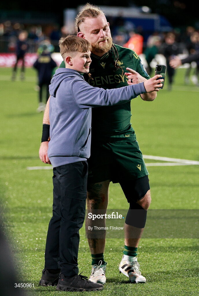 9 May 2026; Finlay Bealham has his photo taken with a supporter on the pitch after the United Rugby Championship match between Connacht and Munster at Dexcom Stadium in Galway. Photo by Thomas Flinkow/Sportsfile
