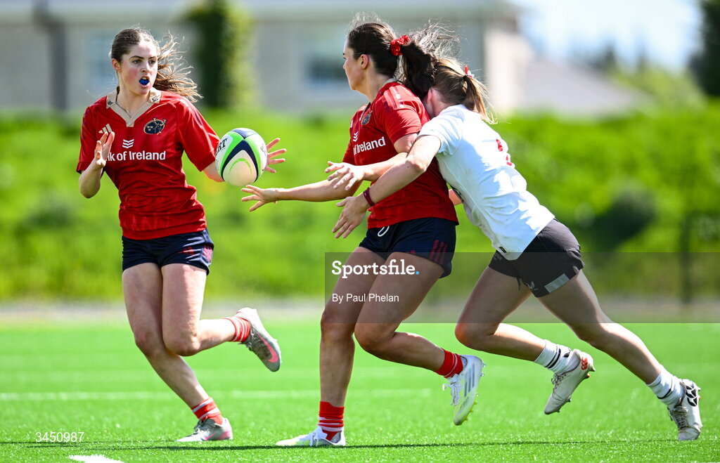 9 May 2026; Cate Foley of Munster 1 passes the ball to Keelin O'Shea despite the tackle of Brooke Watt of Ulster 2 during the IRFU U18 Girls 7s Interprovincial Series match between Munster 1 and Ulster 2 at Mullingar RFC in Westmeath. Photo by Paul Phelan/Sportsfile