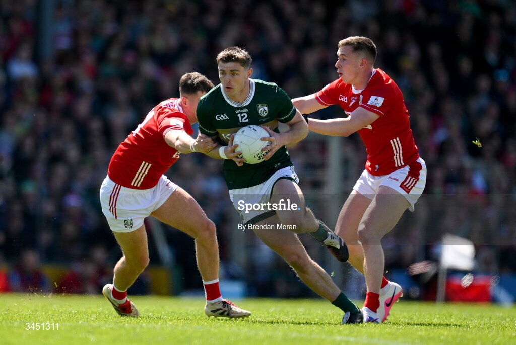 10 May 2026; Diarmuid O'Connor of Kerry is tackled by Seán McDonnell and Luke Fahy of Cork during the Munster GAA Football Senior Championship final match between Kerry and Cork at Fitzgerald Stadium in Killarney, Kerry. Photo by Brendan Moran/Sportsfile