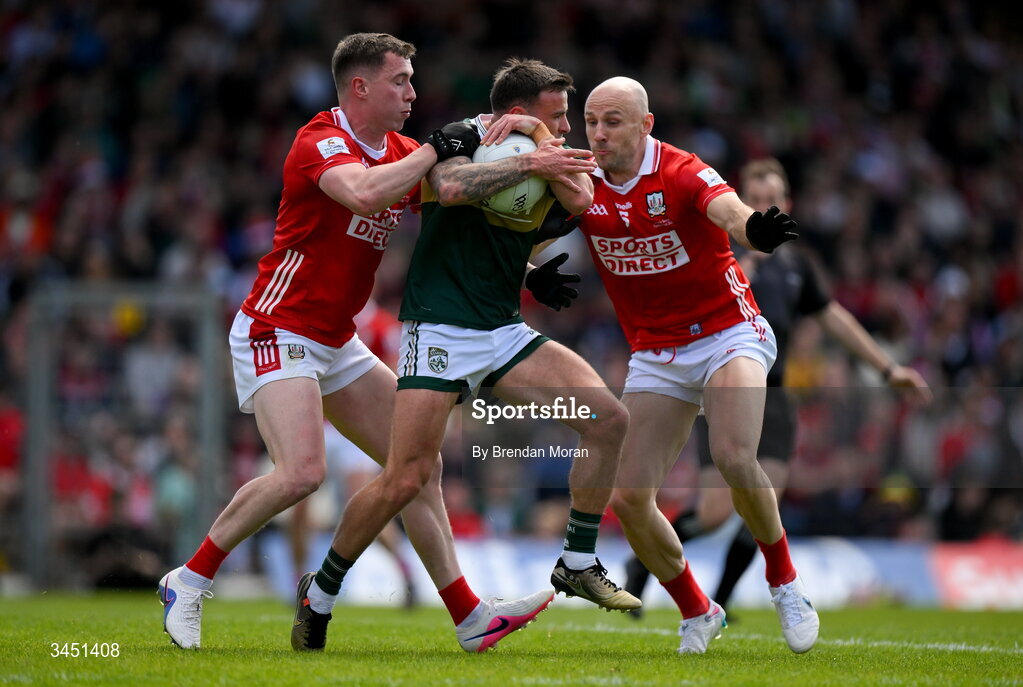 10 May 2026; Micheál Burns of Kerry is tackled by Luke Fahy, left, and Brian O’Driscoll of Cork during the Munster GAA Football Senior Championship final match between Kerry and Cork at Fitzgerald Stadium in Killarney, Kerry. Photo by Brendan Moran/Sportsfile