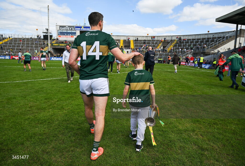 10 May 2026; Páidí Geaney, son of Kerry captain Paul Geaney, carries the Corn Pháidí Uí Shé, named in honour of his grandfather, legendary Kerry footballer Páidí Ó Sé, as they leave the pitch after the Munster GAA Football Senior Championship final match between Kerry and Cork at Fitzgerald Stadium in Killarney, Kerry. Photo by Brendan Moran/Sportsfile