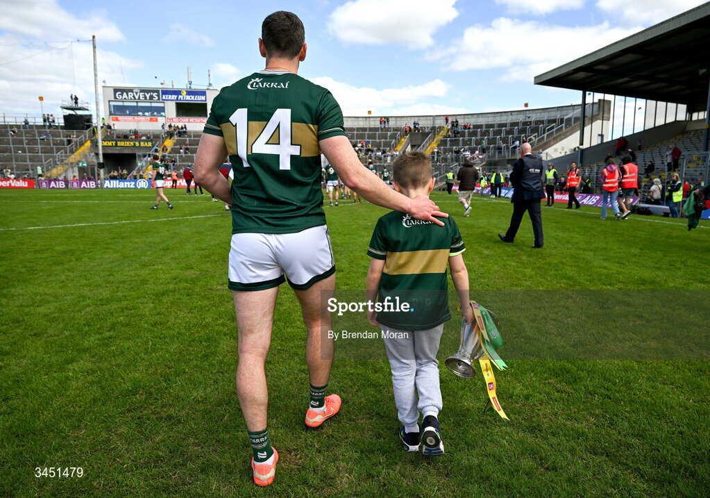 10 May 2026; Páidí Geaney, son of Kerry captain Paul Geaney, carries the Corn Pháidí Uí Shé, named in honour of his grandfather, legendary Kerry footballer Páidí Ó Sé, as they leave the pitch after the Munster GAA Football Senior Championship final match between Kerry and Cork at Fitzgerald Stadium in Killarney, Kerry. Photo by Brendan Moran/Sportsfile