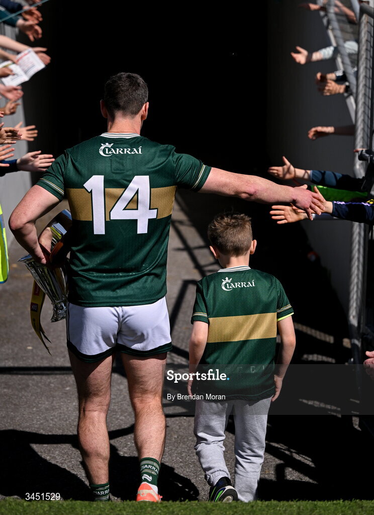 10 May 2026; Kerry captain Paul Geaney, leaves the pitch with his son Páidí, and the Corn Pháidí Uí Shé, named in honour of legendary Kerry footballer Páidí Ó Sé, after the Munster GAA Football Senior Championship final match between Kerry and Cork at Fitzgerald Stadium in Killarney, Kerry. Photo by Brendan Moran/Sportsfile