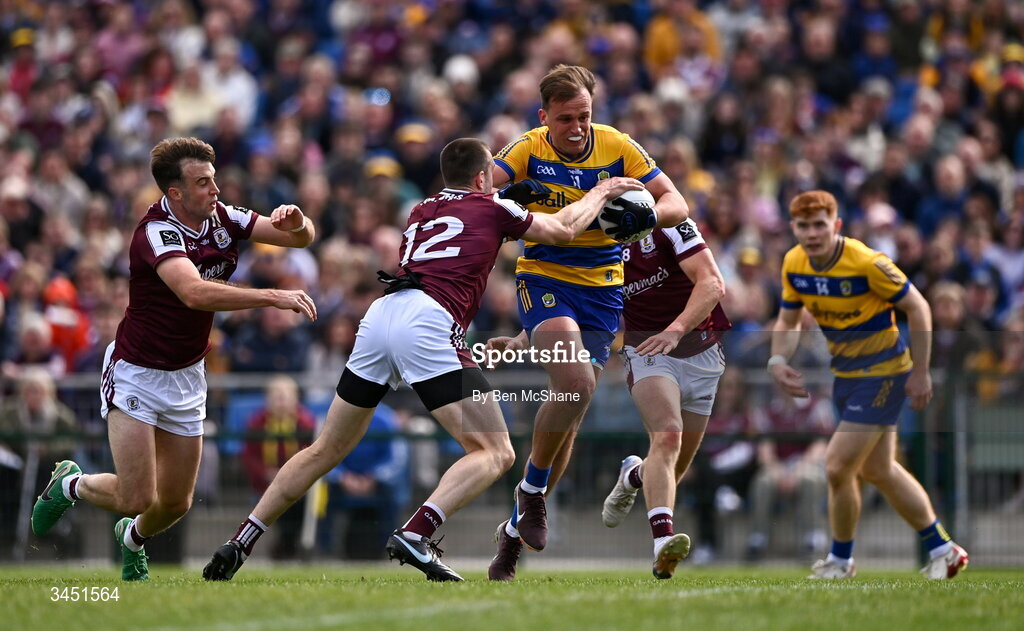 10 May 2026; Enda Smith of Roscommon is tackled by Galway players, from left, Paul Conroy, Céin D'Arcy and Kieran Molloy during the Connacht GAA Football Senior Championship final match between Roscommon and Galway at King & Moffatt Dr Hyde Park in Roscommon. Photo by Ben McShane/Sportsfile