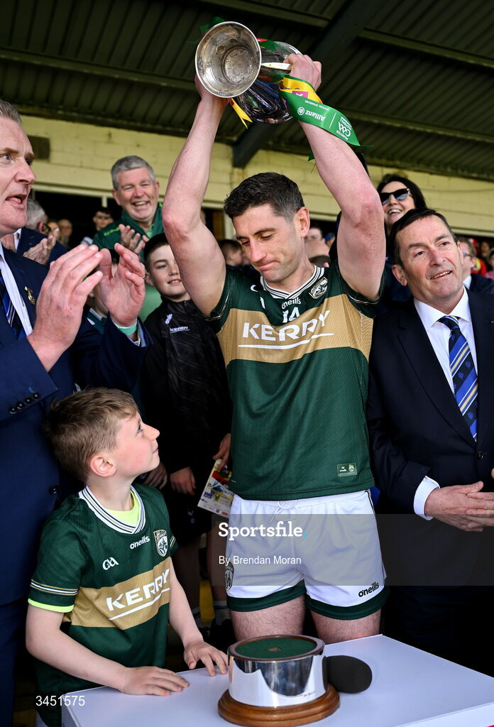 10 May 2026; Páidí Geaney looks at his father, Kerry captain Paul Geaney, after presenting him with the Corn Pháidí Uí Shé, named in honour of his grandfather, legendary Kerry footballer Páidí Ó Sé, after the Munster GAA Football Senior Championship final match between Kerry and Cork at Fitzgerald Stadium in Killarney, Kerry. Photo by Brendan Moran/Sportsfile